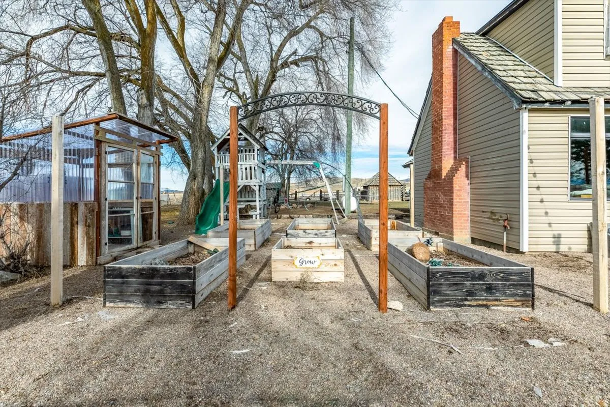View of patio / terrace with a vegetable garden and an outbuilding