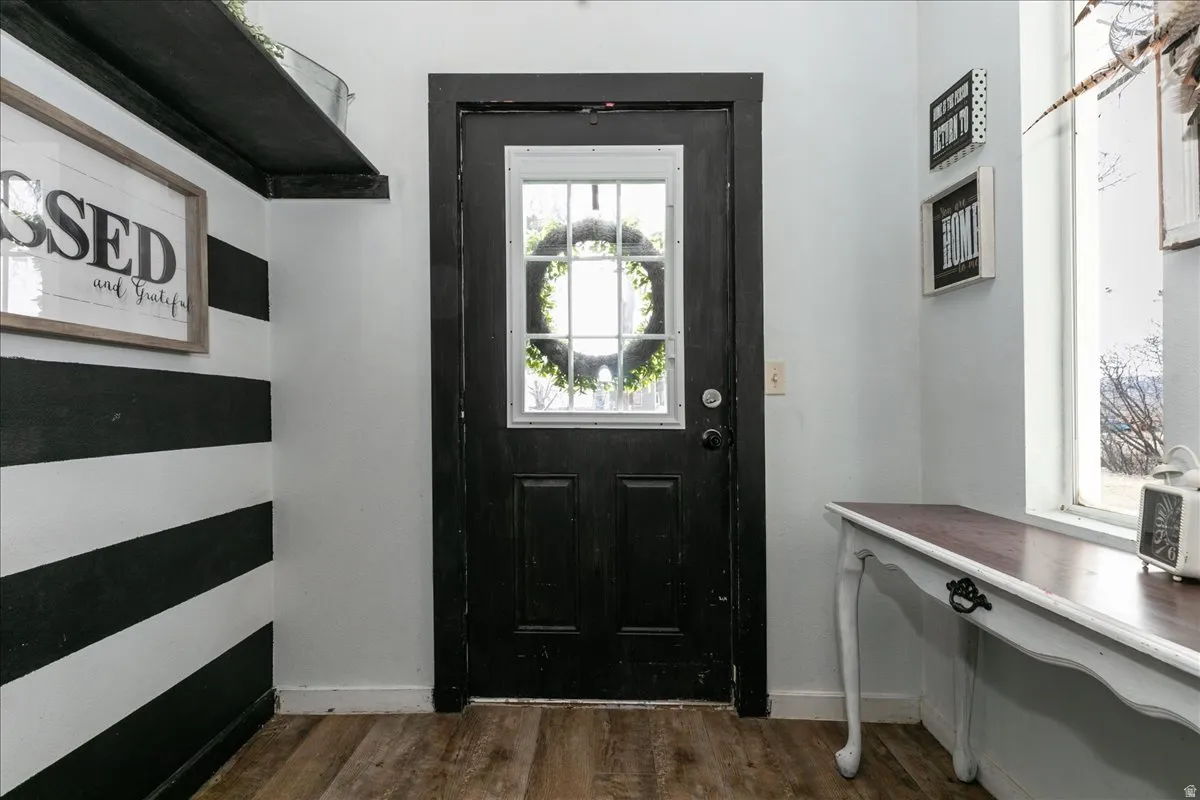 Entryway featuring wood finished floors and baseboards