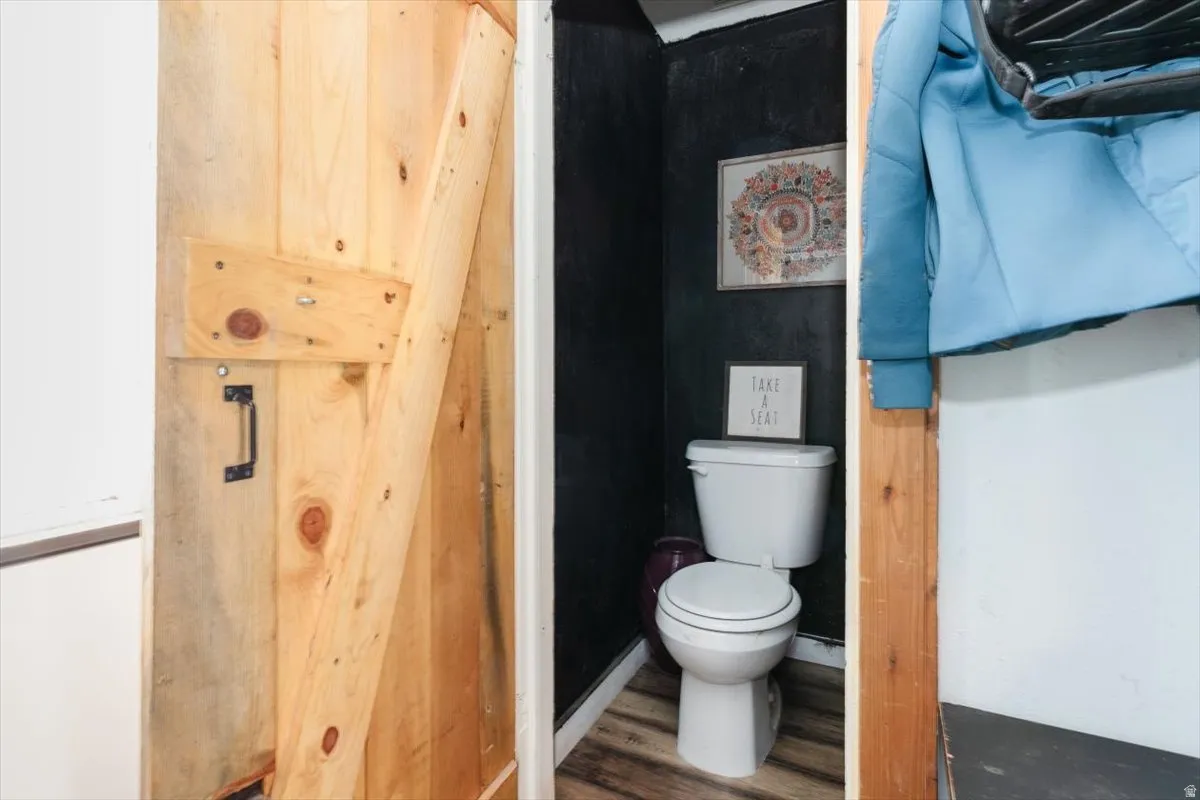 Bathroom with toilet and wood finished floors