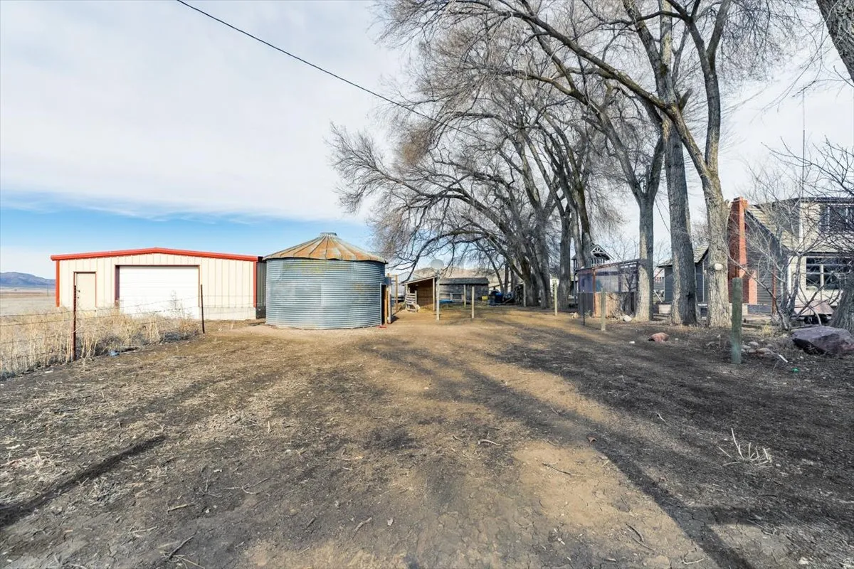 View of yard with an outbuilding and a detached garage