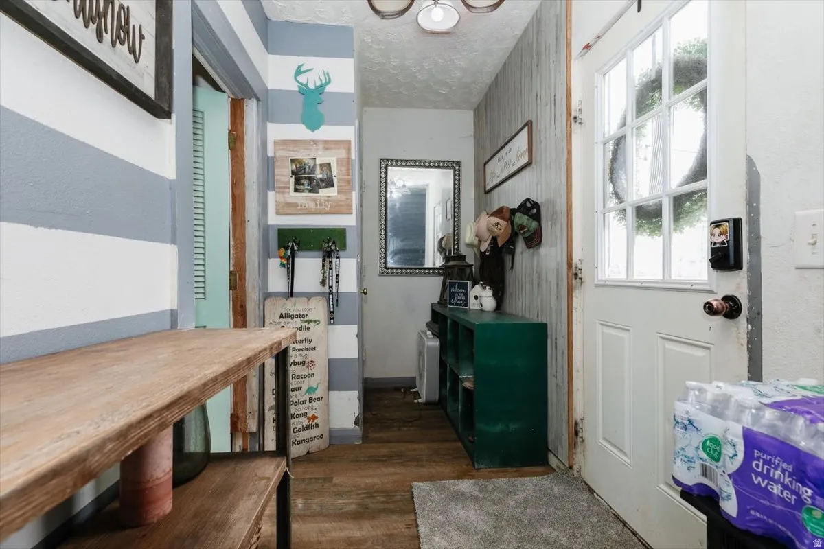 Entryway featuring dark wood-type flooring and a textured ceiling