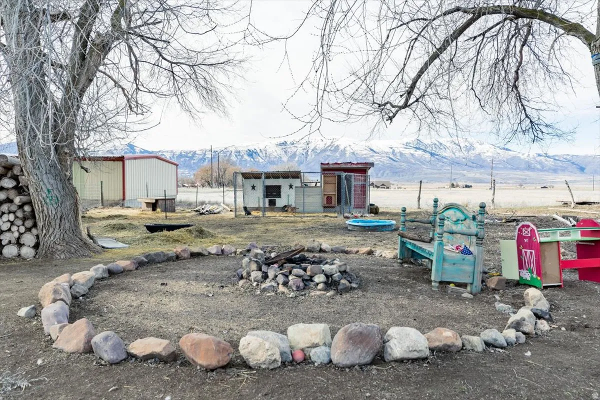 View of yard with an outbuilding, a mountain view, and exterior structure