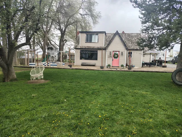 View of front facade with a front lawn, a trampoline, and a playground