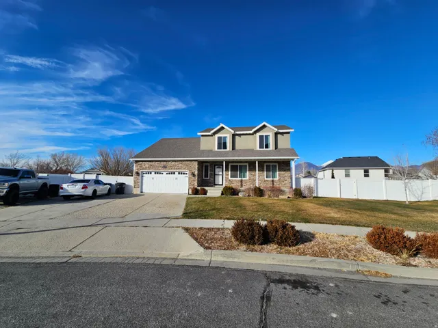Traditional-style home with covered porch, concrete driveway, a garage, and a shingled roof