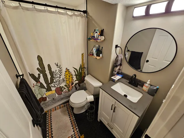 Bathroom featuring vanity and curtained shower