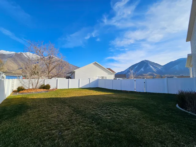 Fenced backyard with a mountain view
