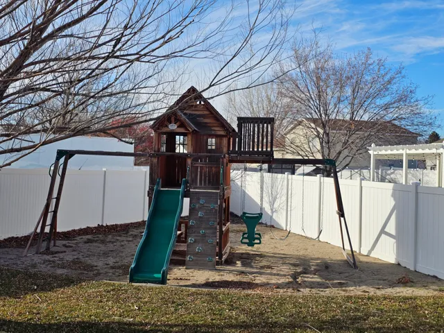 View of play area featuring a fenced backyard