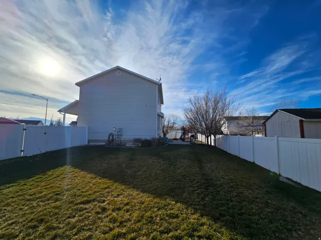View of home's exterior featuring a fenced backyard and a gate