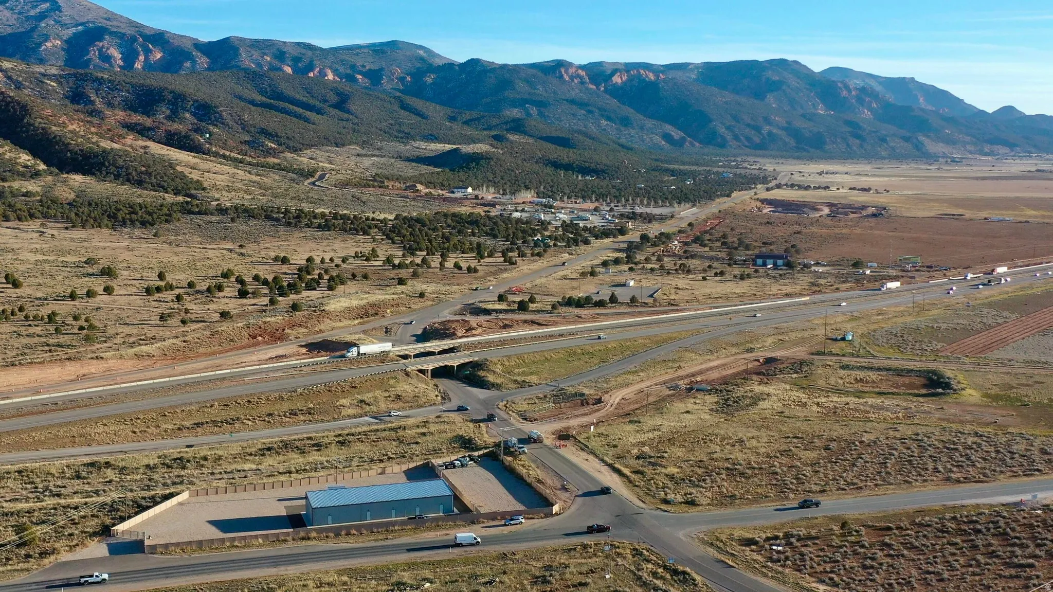 Aerial overview of property's location featuring a mountain backdrop and rural landscape