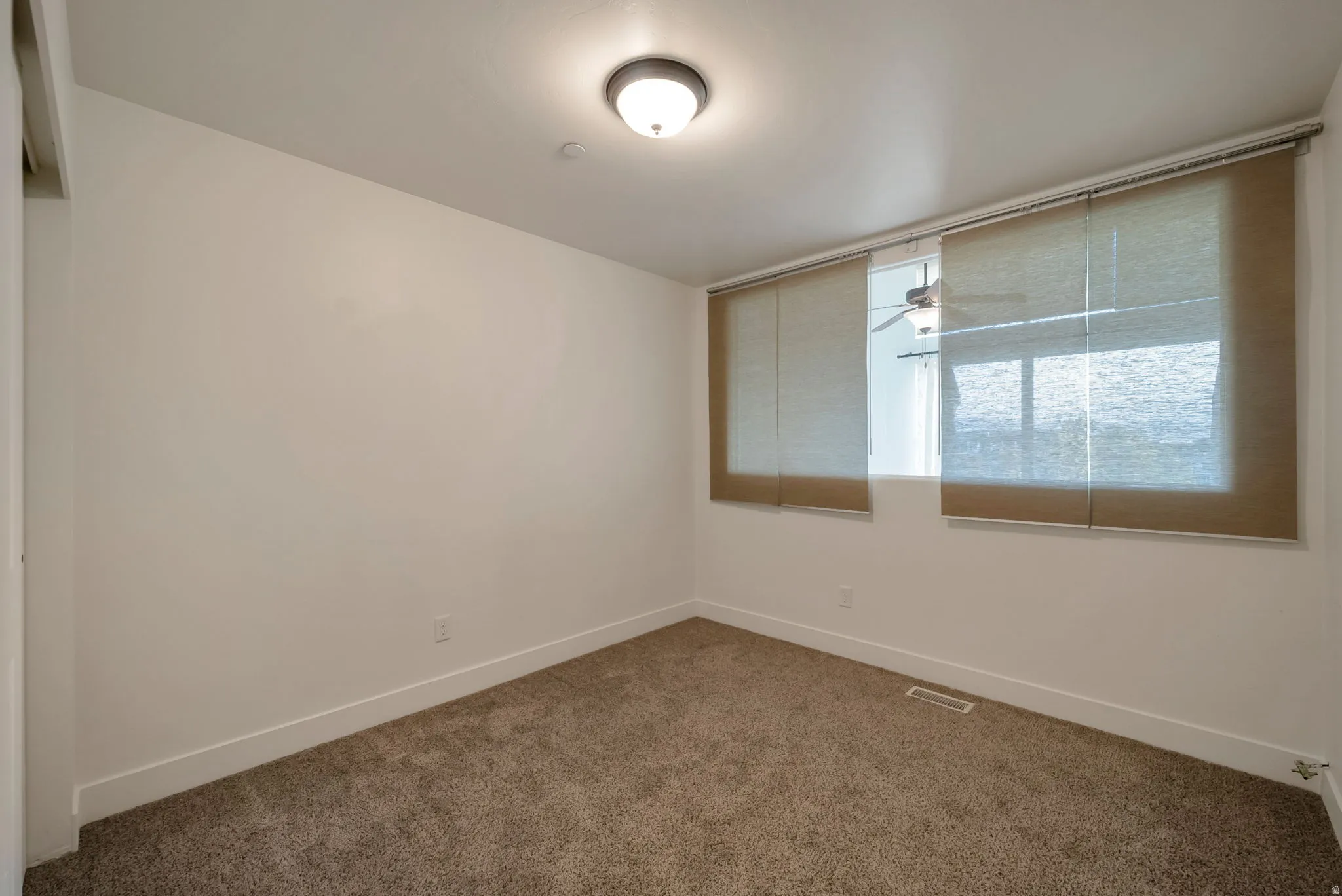 Unfurnished room with carpet flooring and baseboards