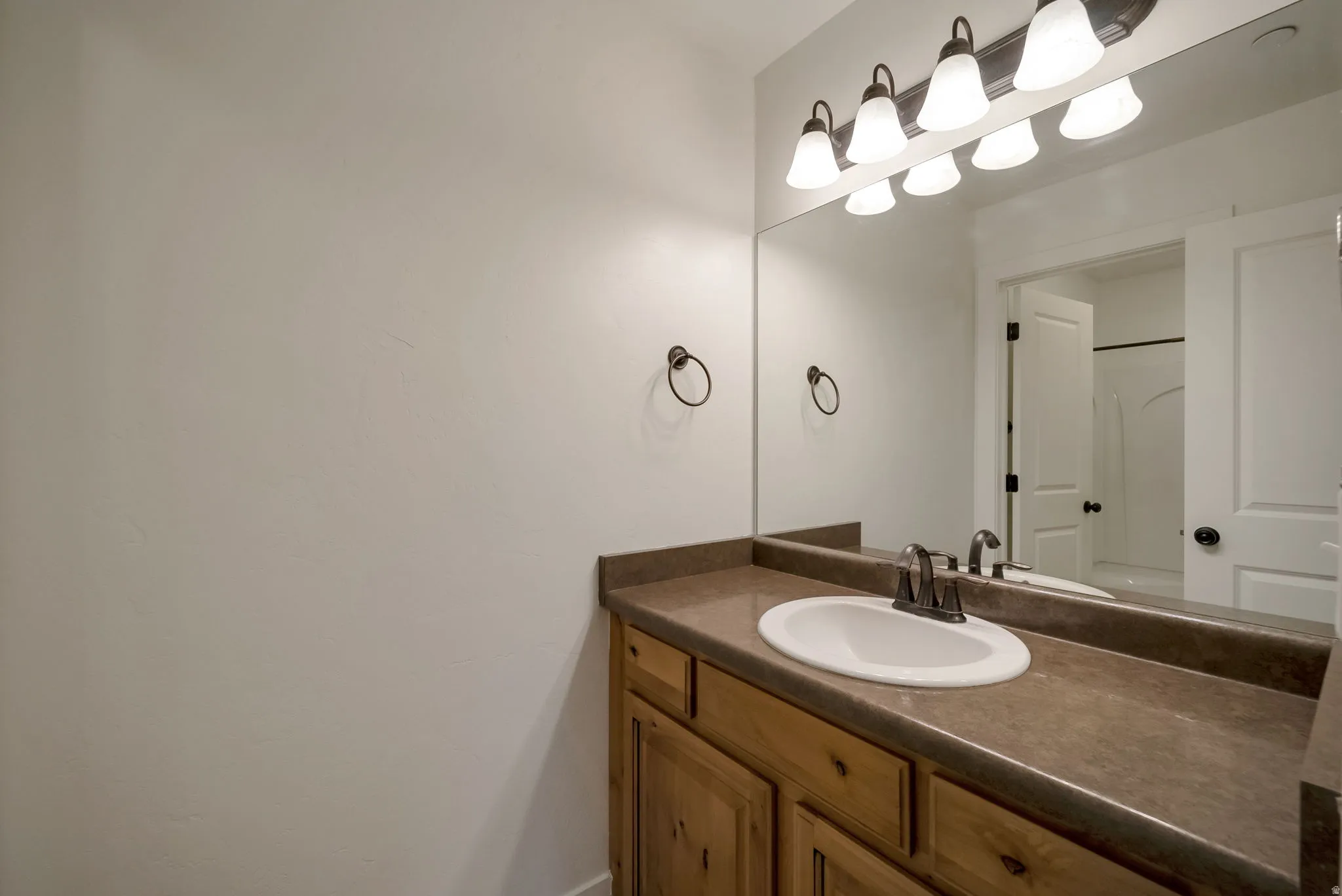Bathroom with vanity and a shower