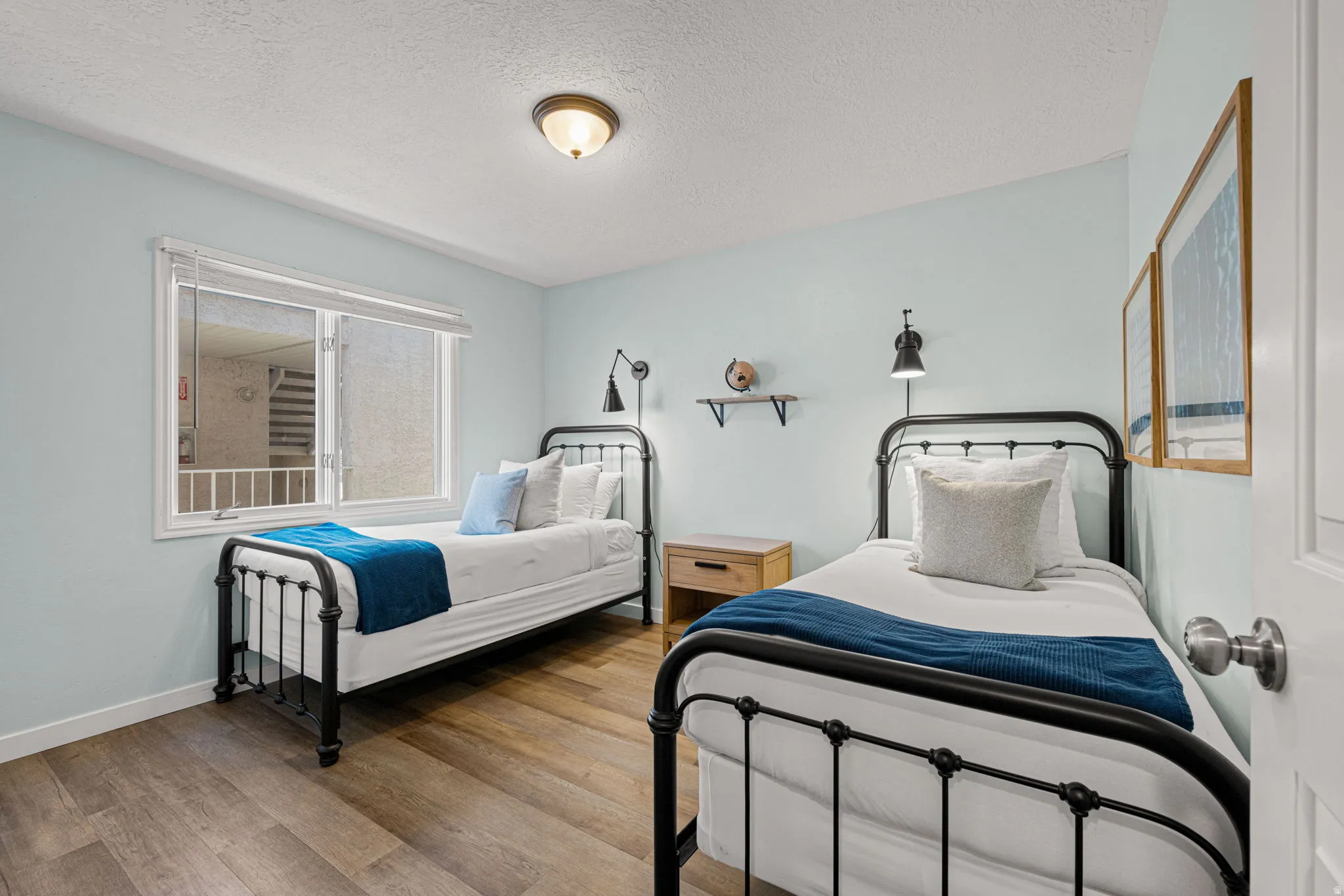 Bedroom featuring a textured ceiling and wood finished floors