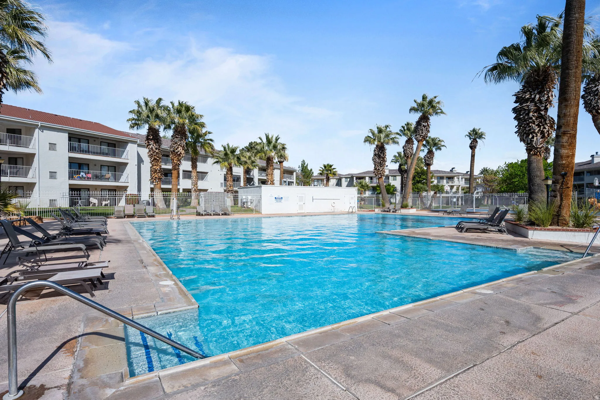 Community pool with a patio