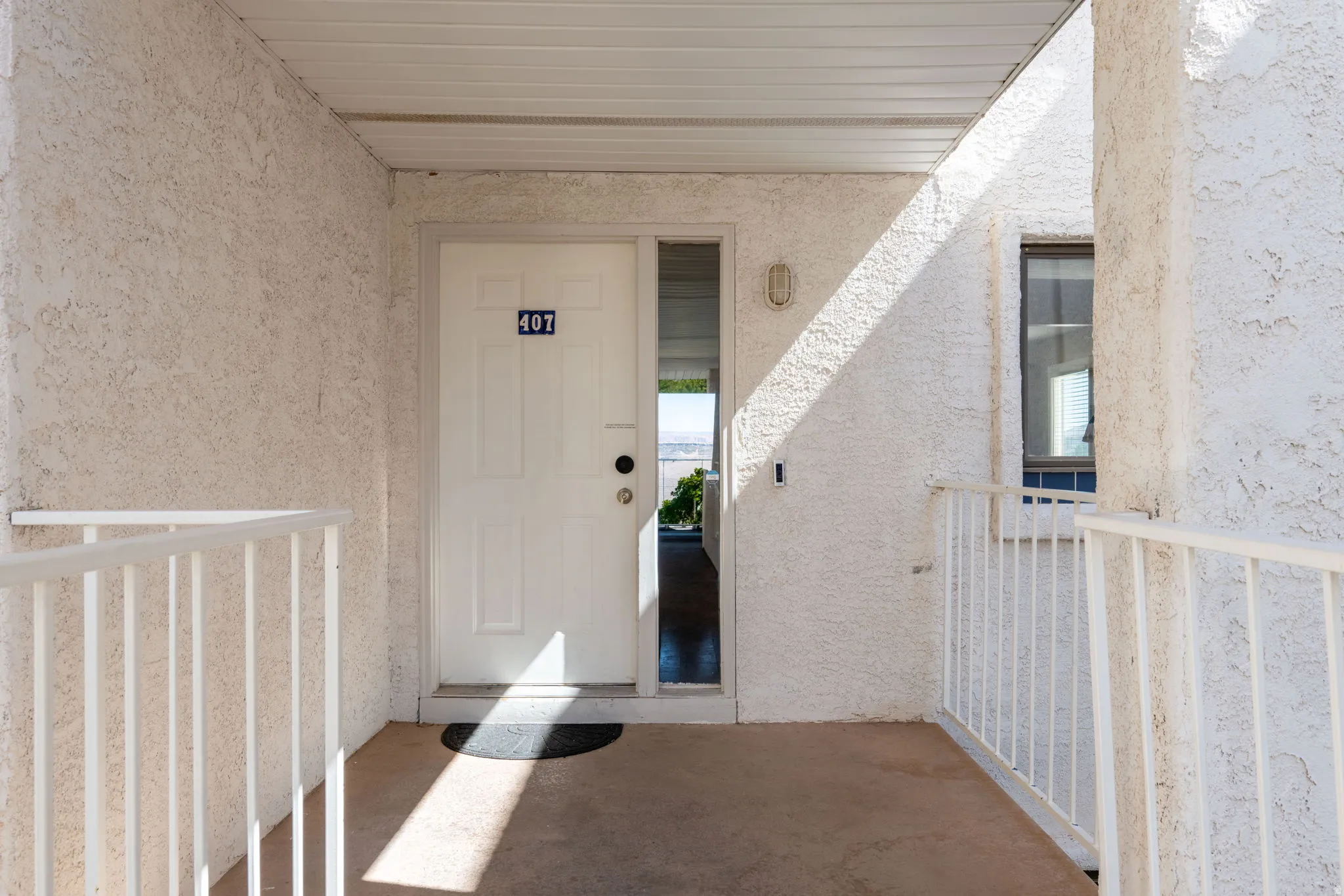 Entrance to property featuring stucco siding