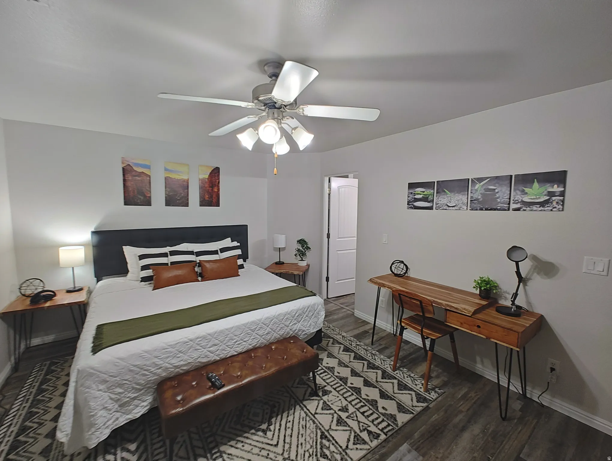 Master Bedroom with dark wood finished floors and ceiling fan