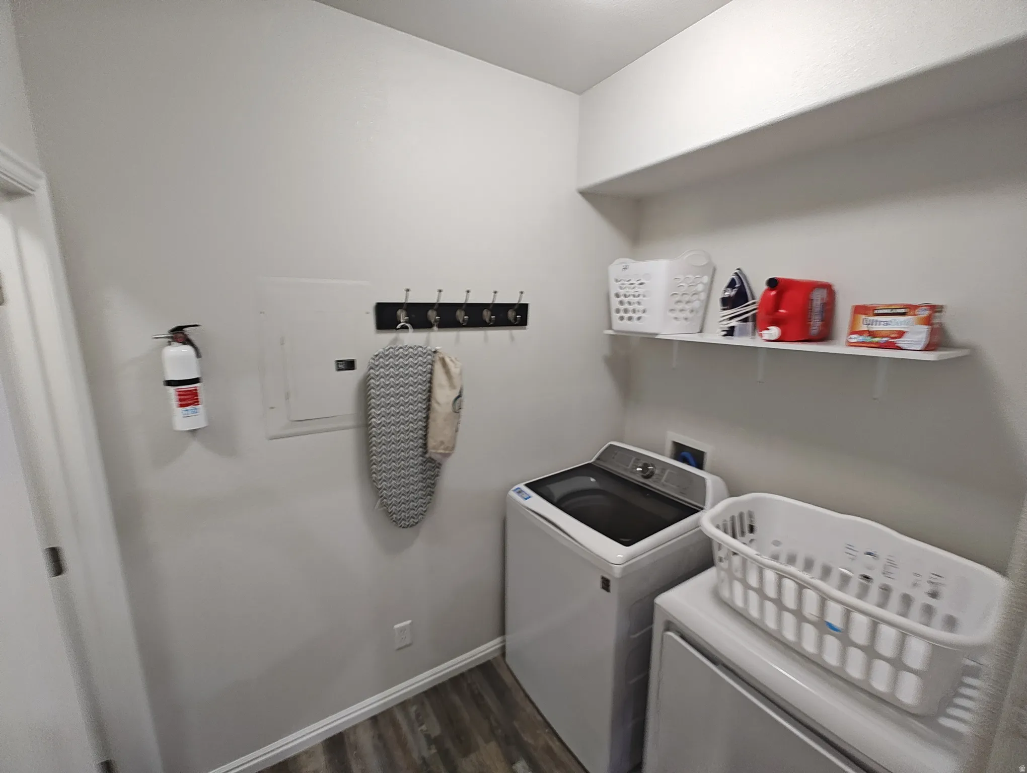Laundry area featuring dark wood finished floors and washer and dryer