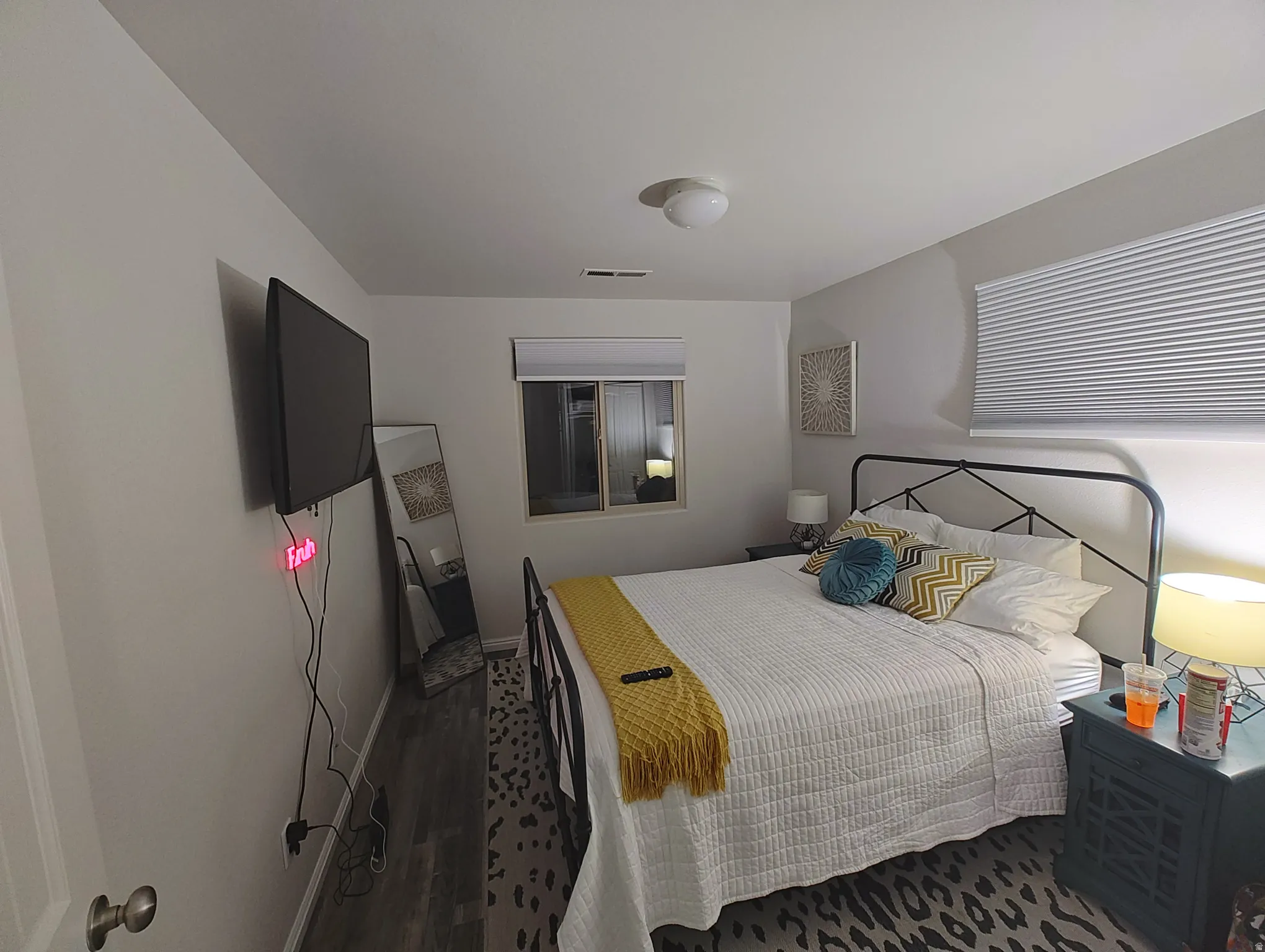 Bedroom with dark wood-style floors and baseboards