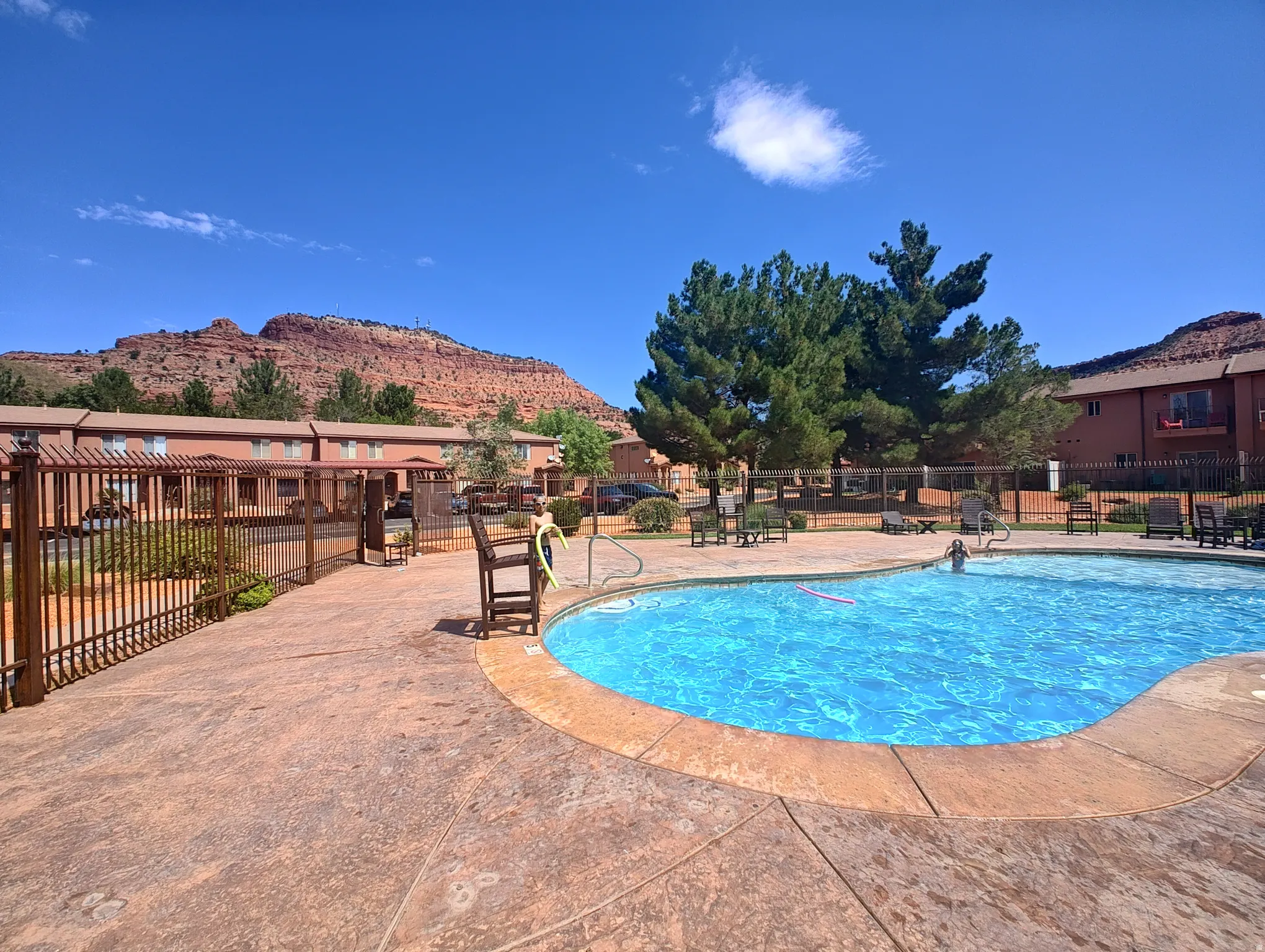 Community pool with a patio area, a mountain view, and area for grilling