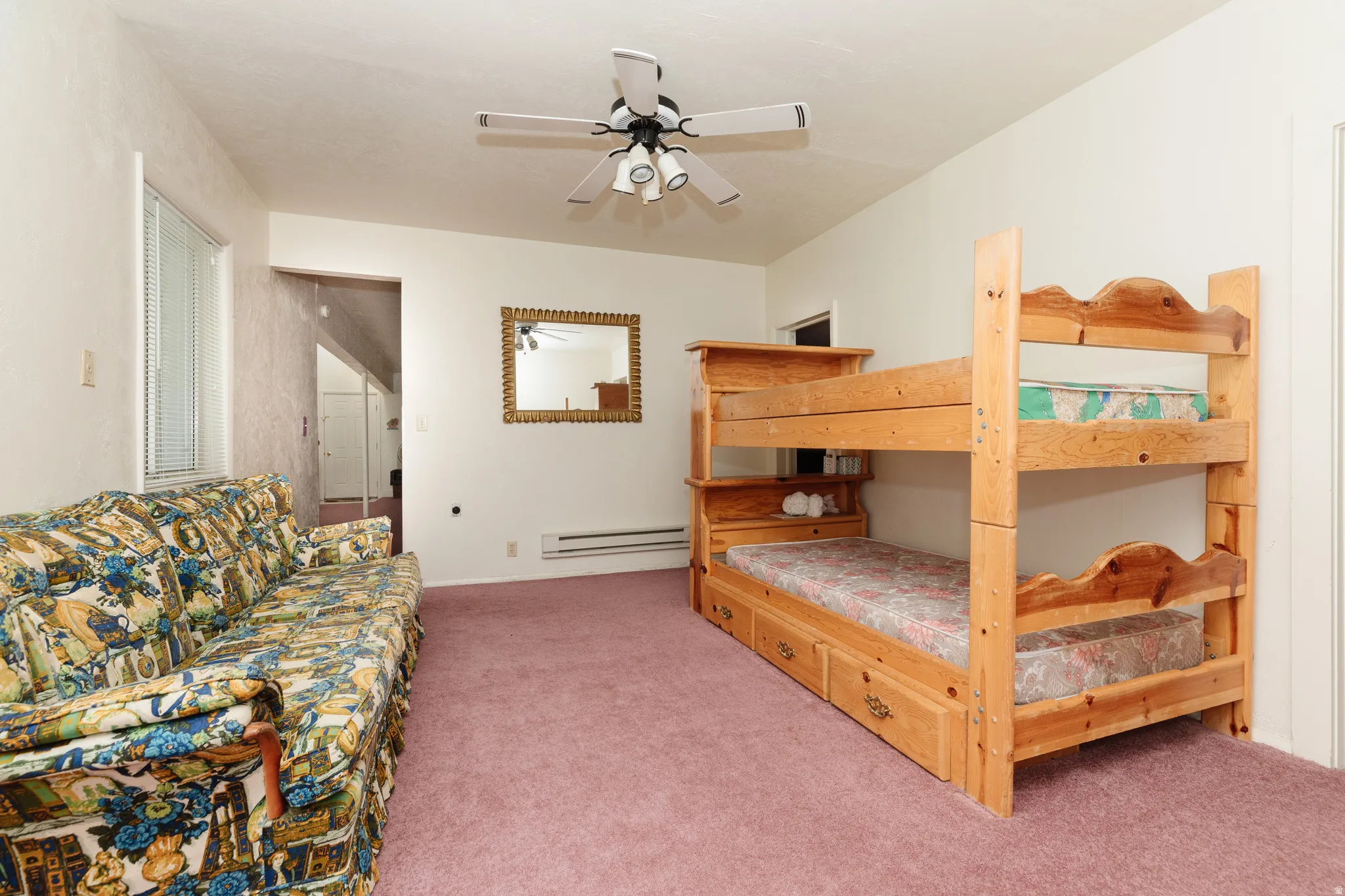 Bedroom featuring carpet, ceiling fan, and a baseboard radiator