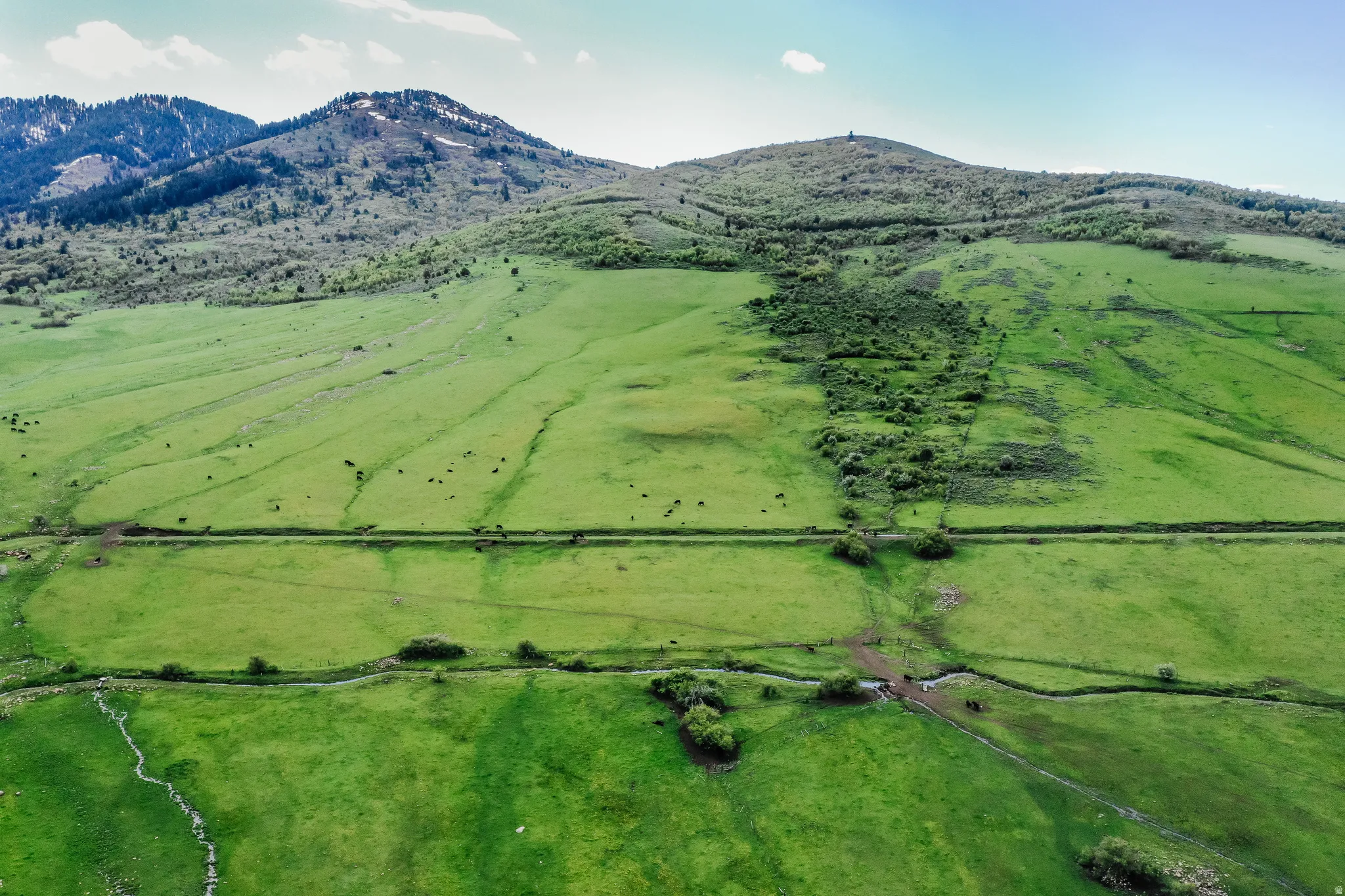 View of mountain backdrop with rural landscape