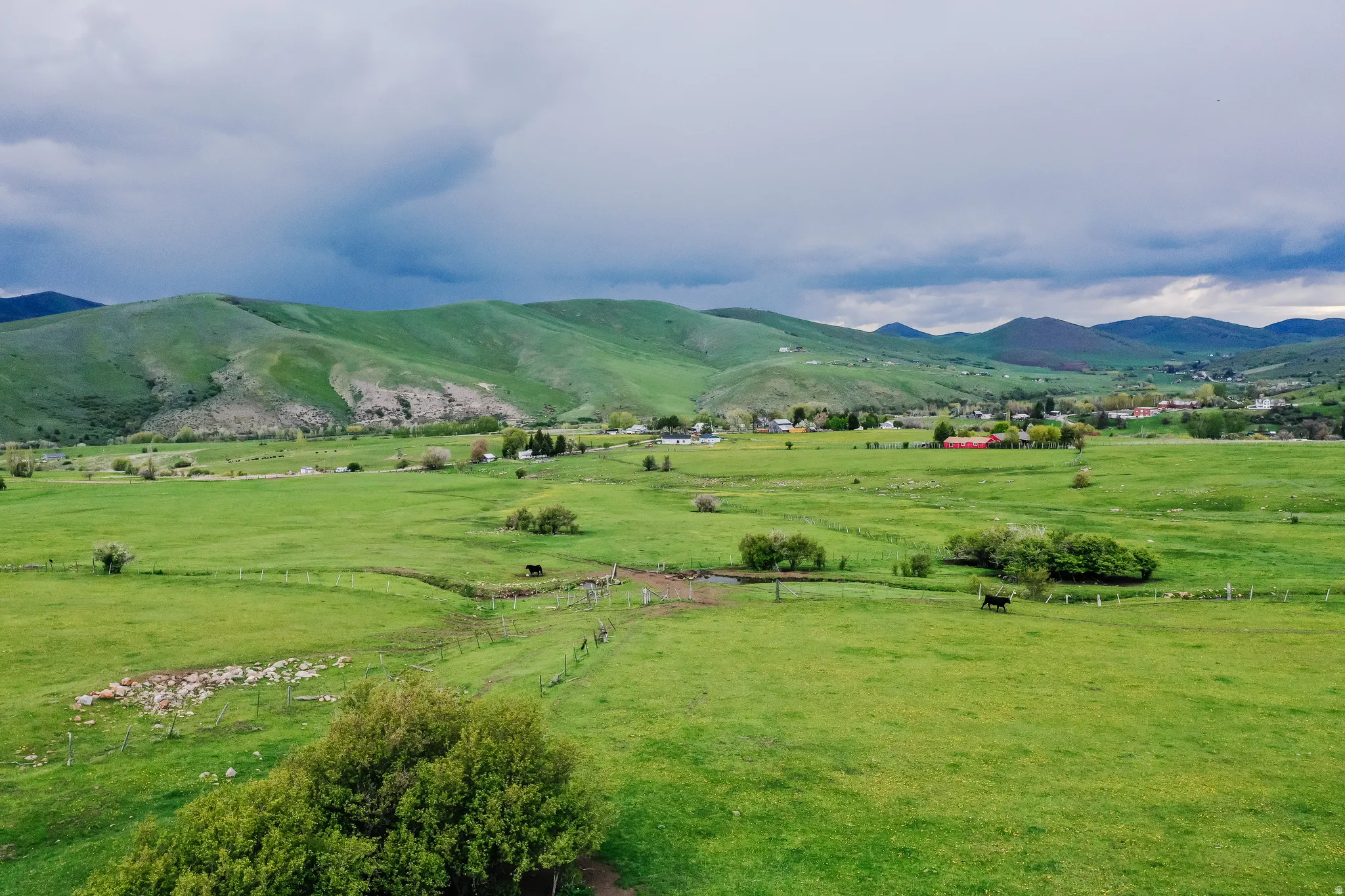 View of mountain backdrop with agricultural land and rural landscape