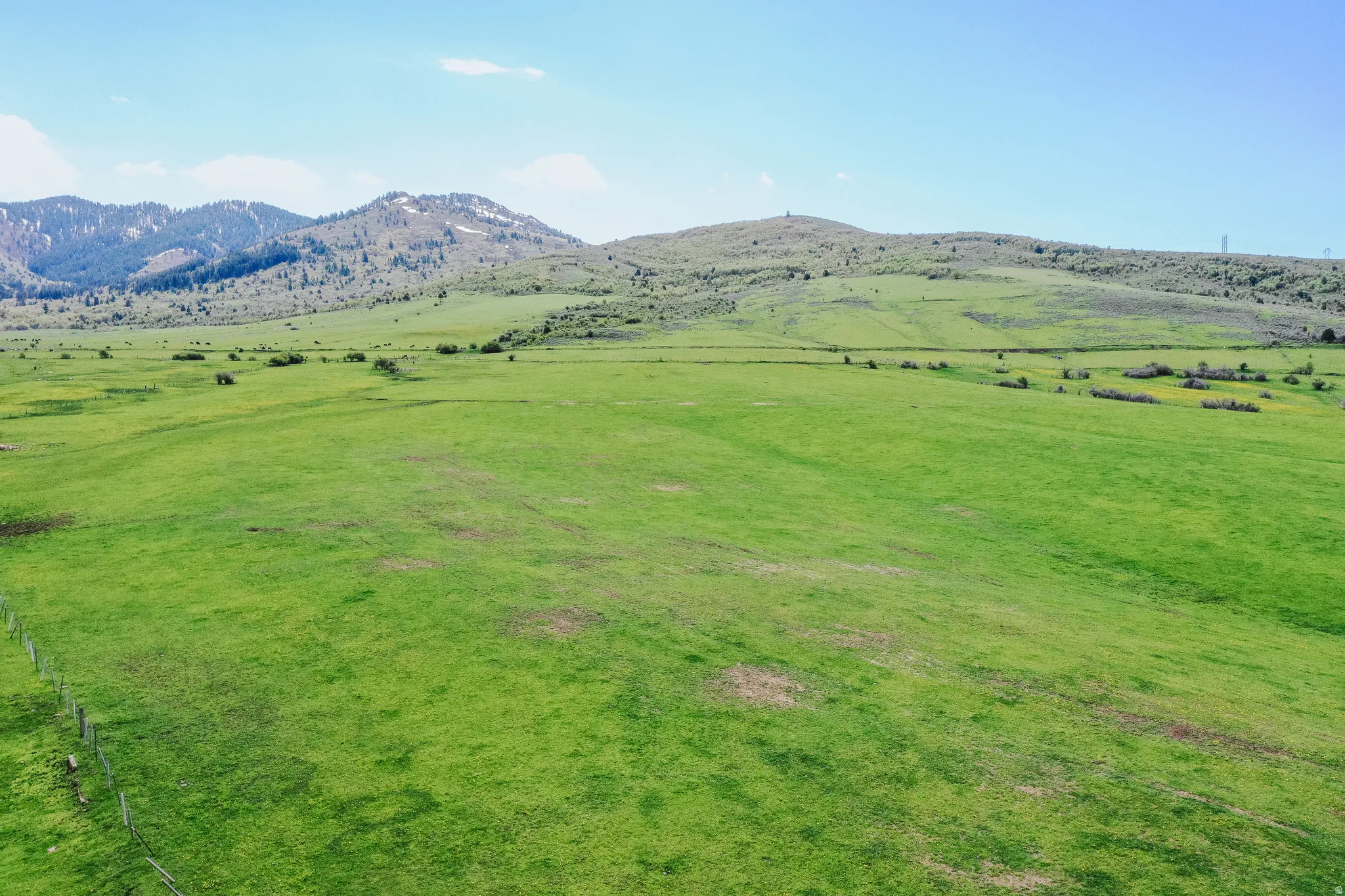 View of mountain backdrop with rural landscape and agricultural land