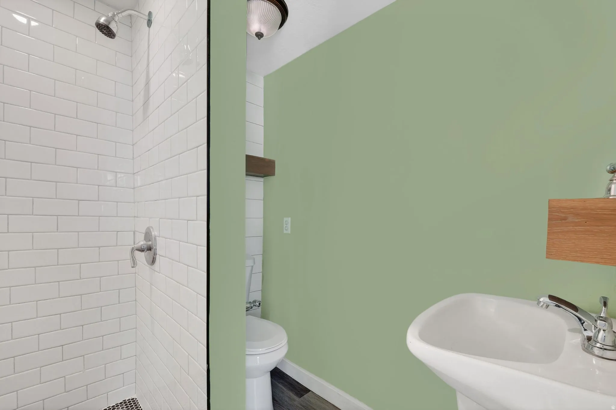 Full bathroom featuring a sink and a tile shower