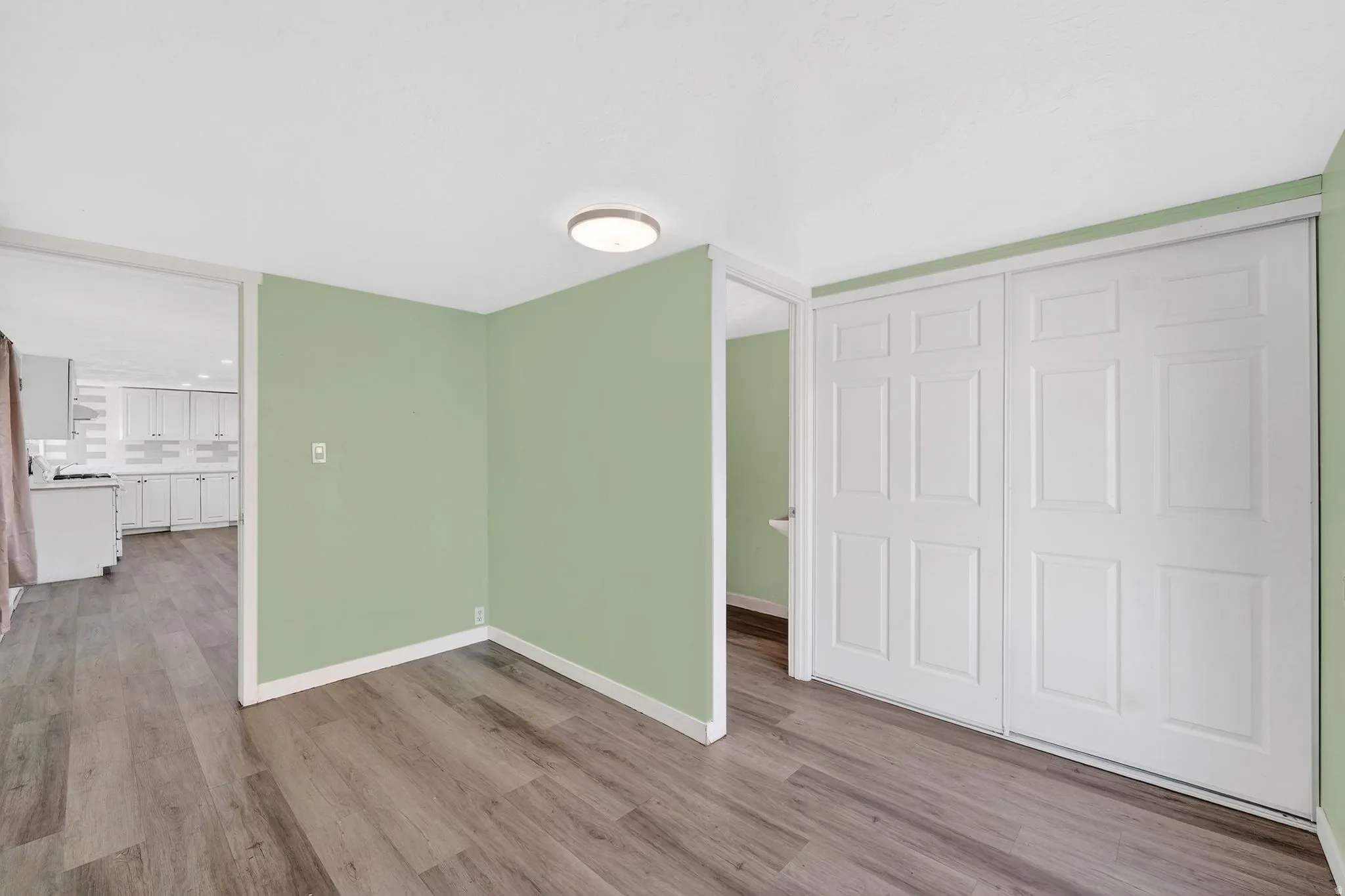 Unfurnished bedroom featuring wood finished floors and a closet