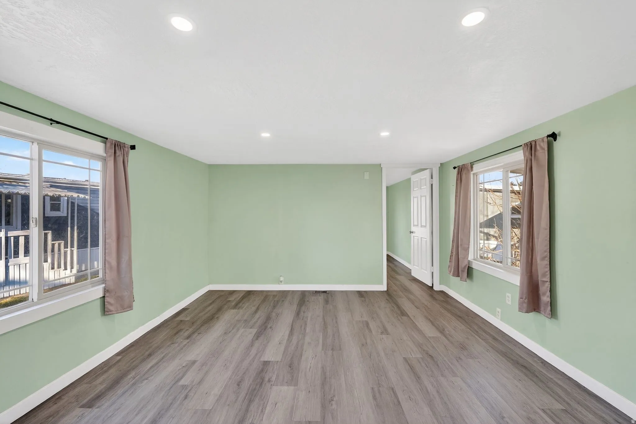 Empty room featuring wood finished floors and recessed lighting