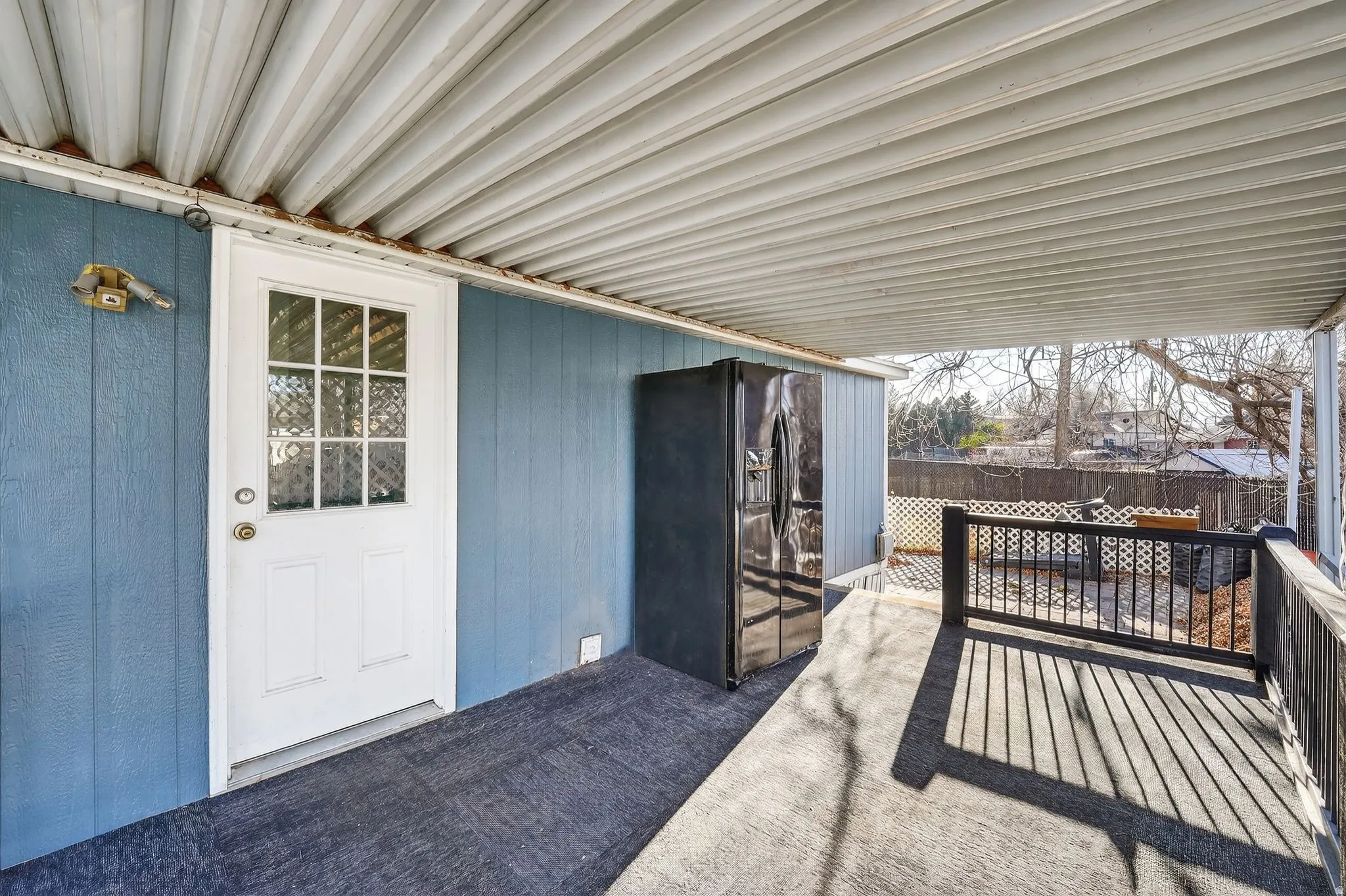 View of exterior entry with a wooden deck