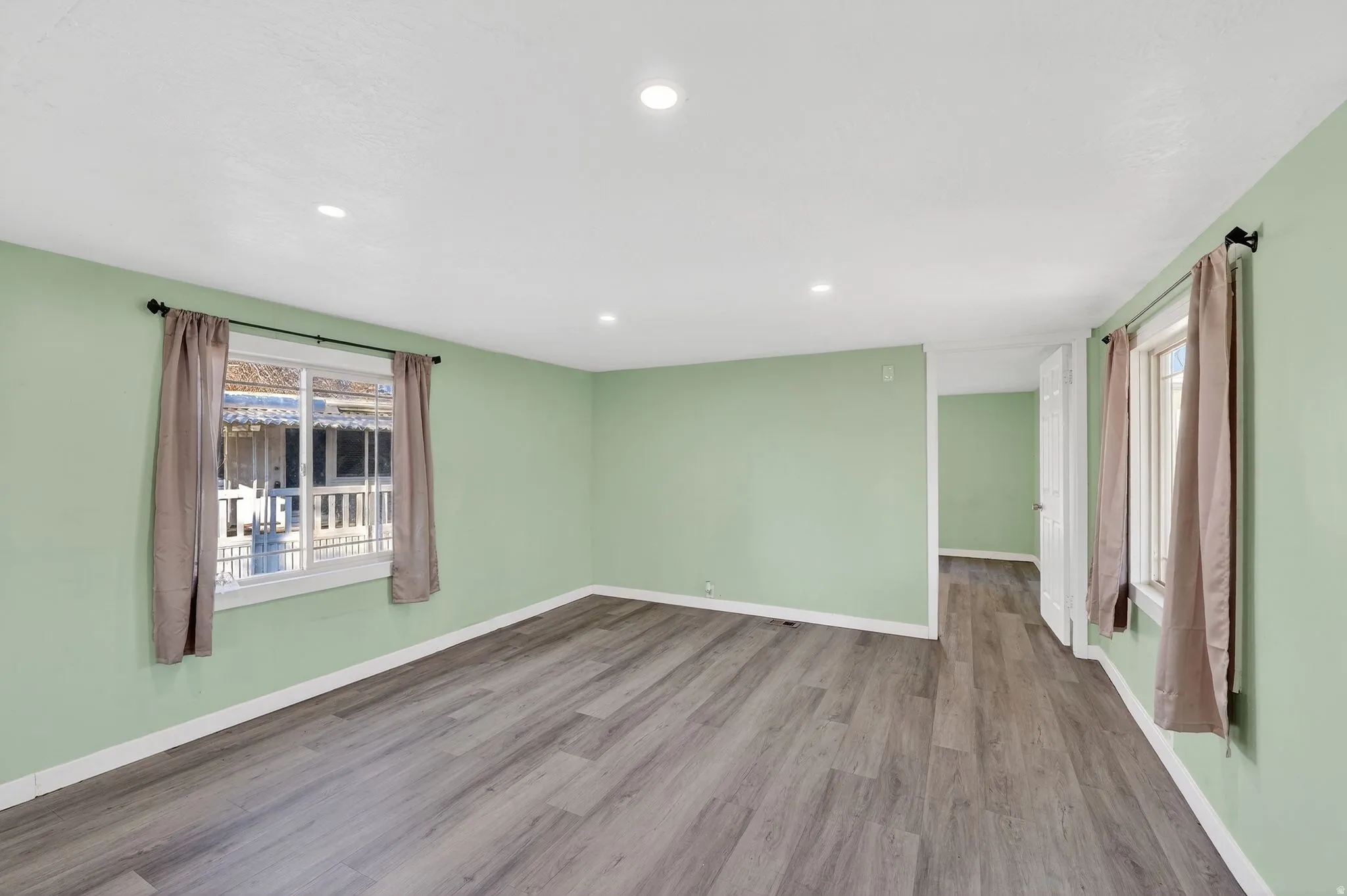 Empty room featuring wood finished floors and recessed lighting