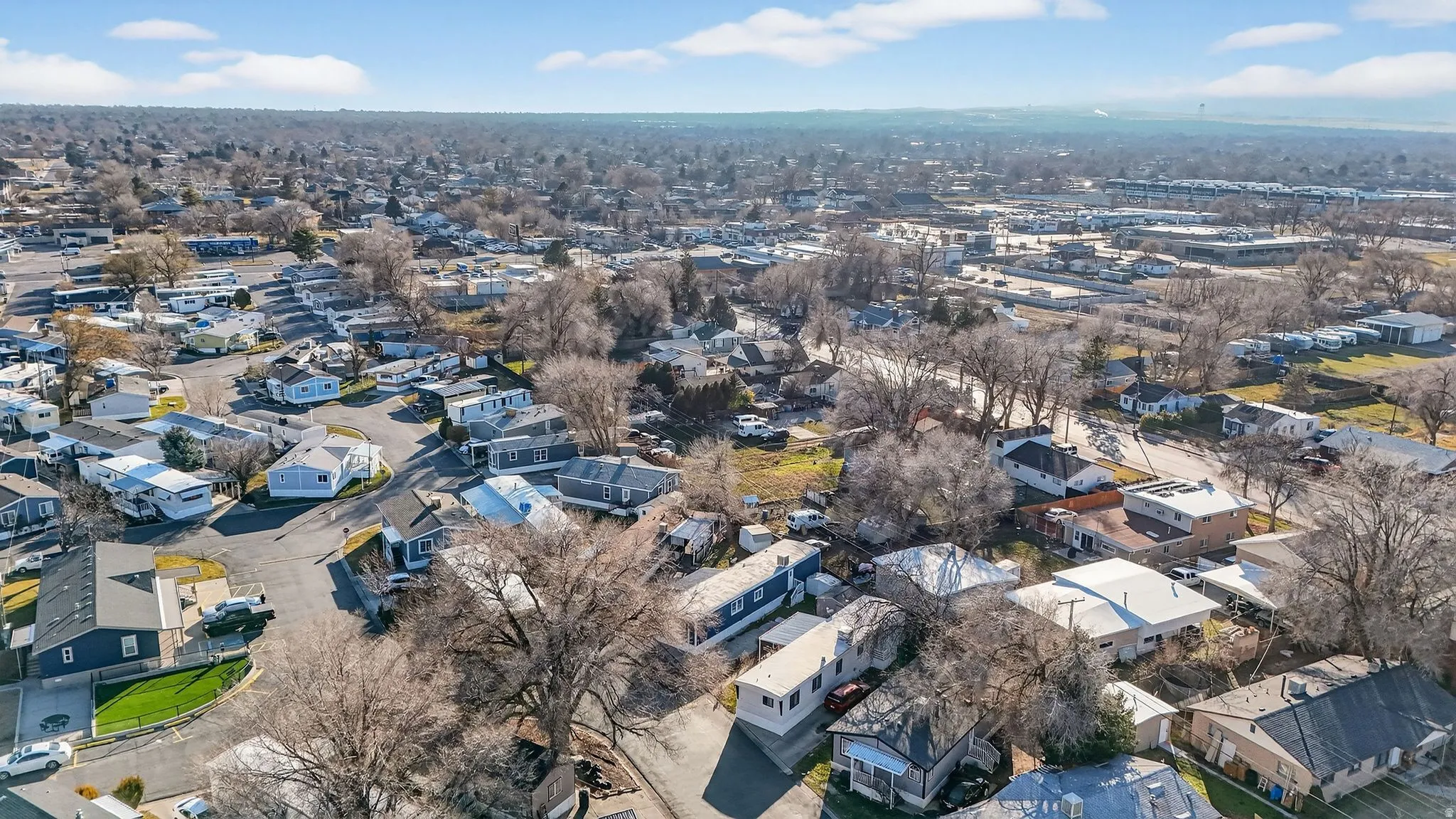 Aerial overview of property's location featuring nearby suburban area