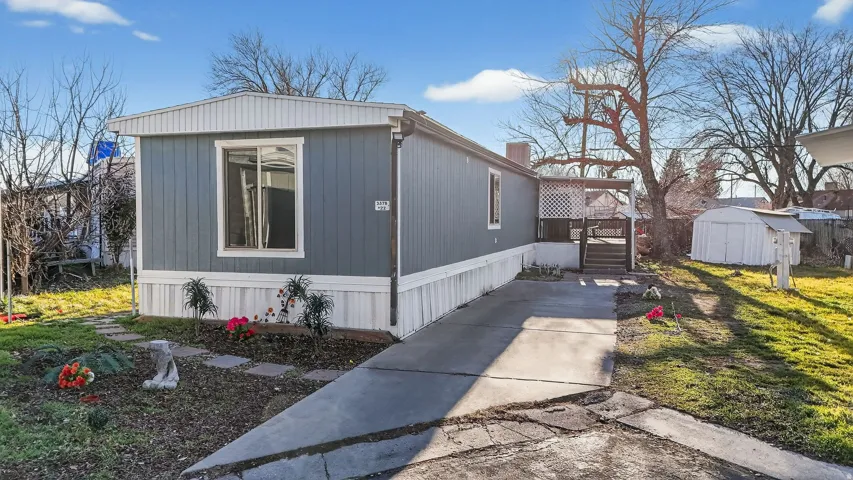 View of property exterior featuring a storage unit