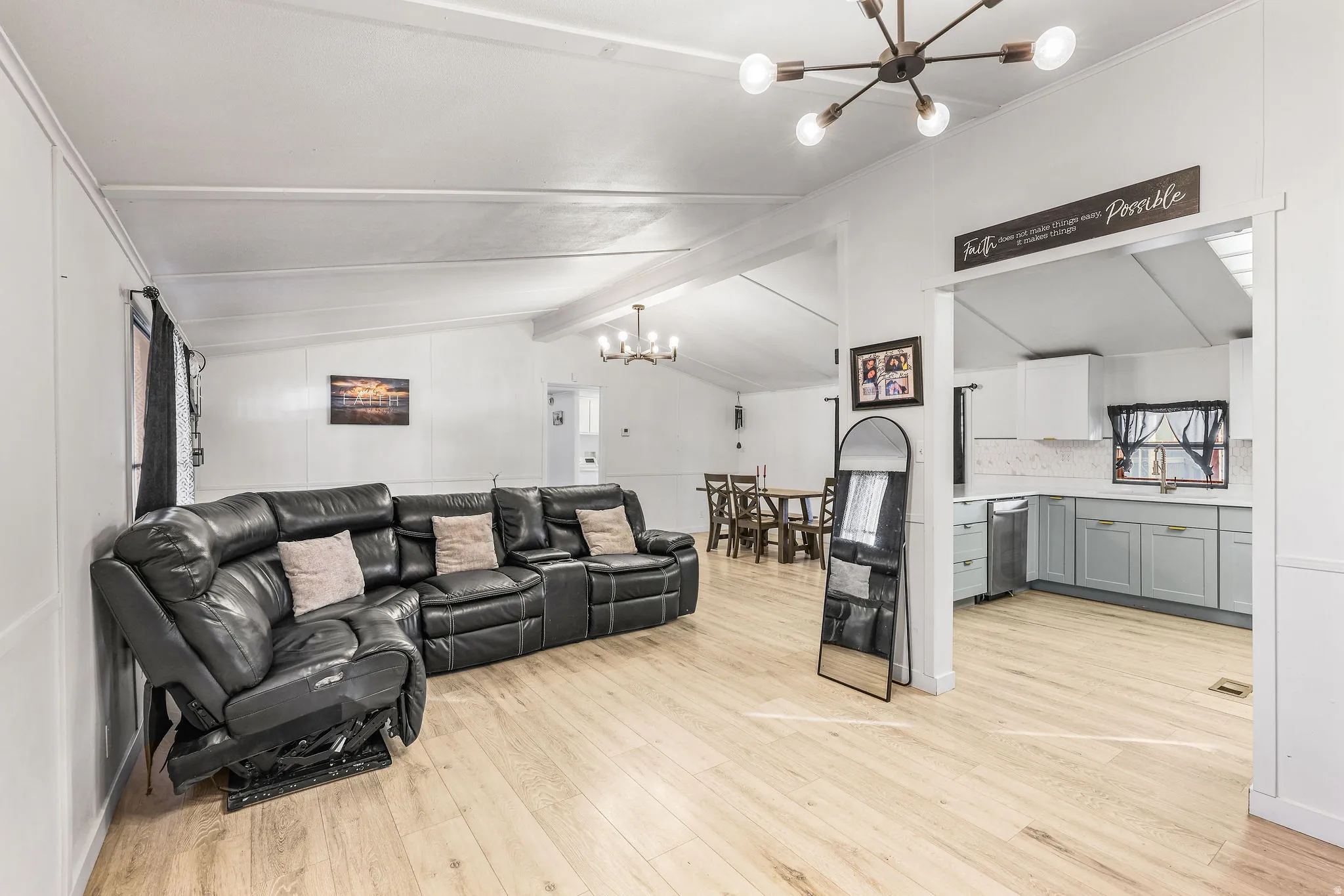 Living area with a chandelier and light wood-type flooring