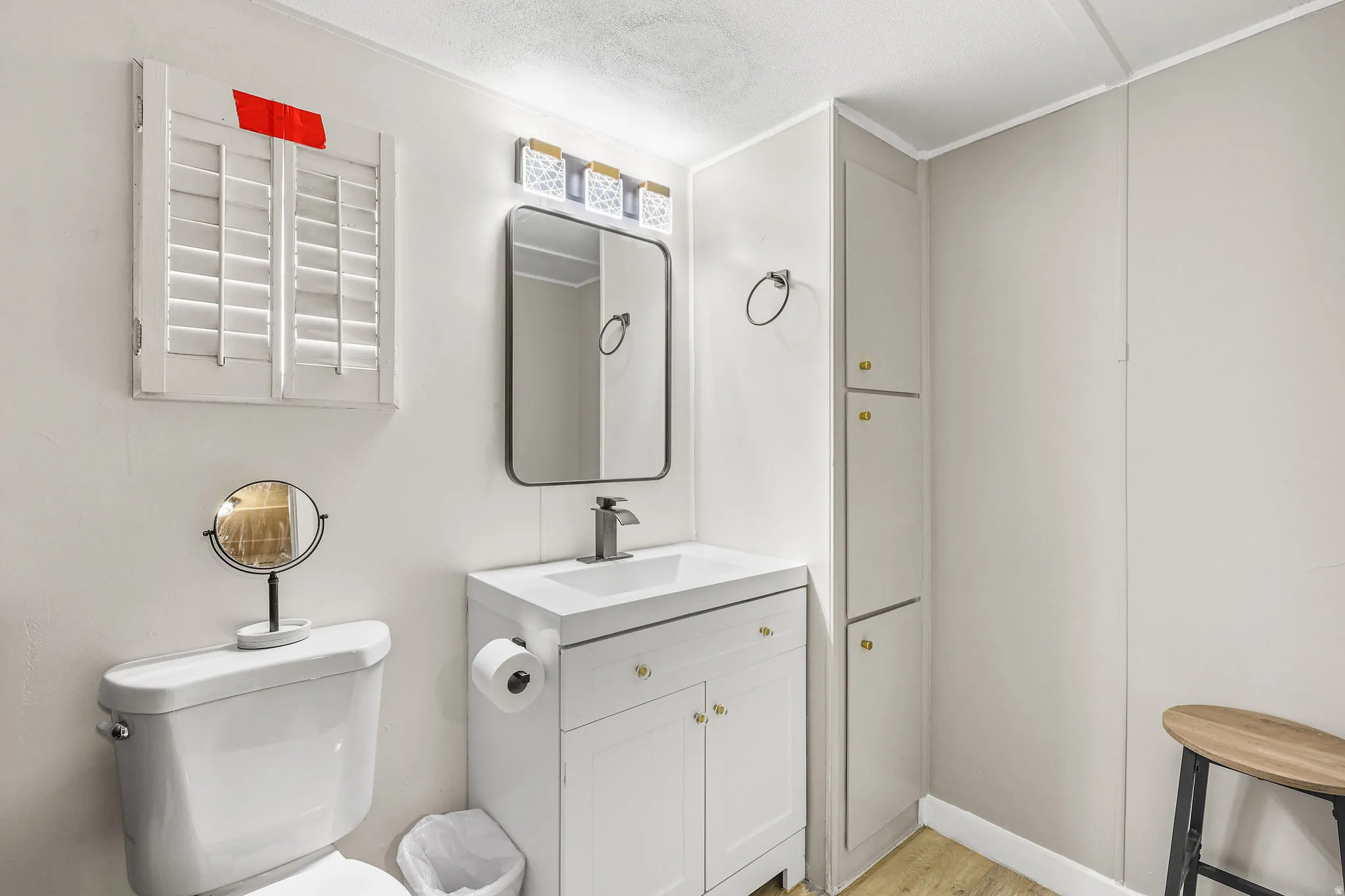 Half bathroom with vanity and light wood-style flooring