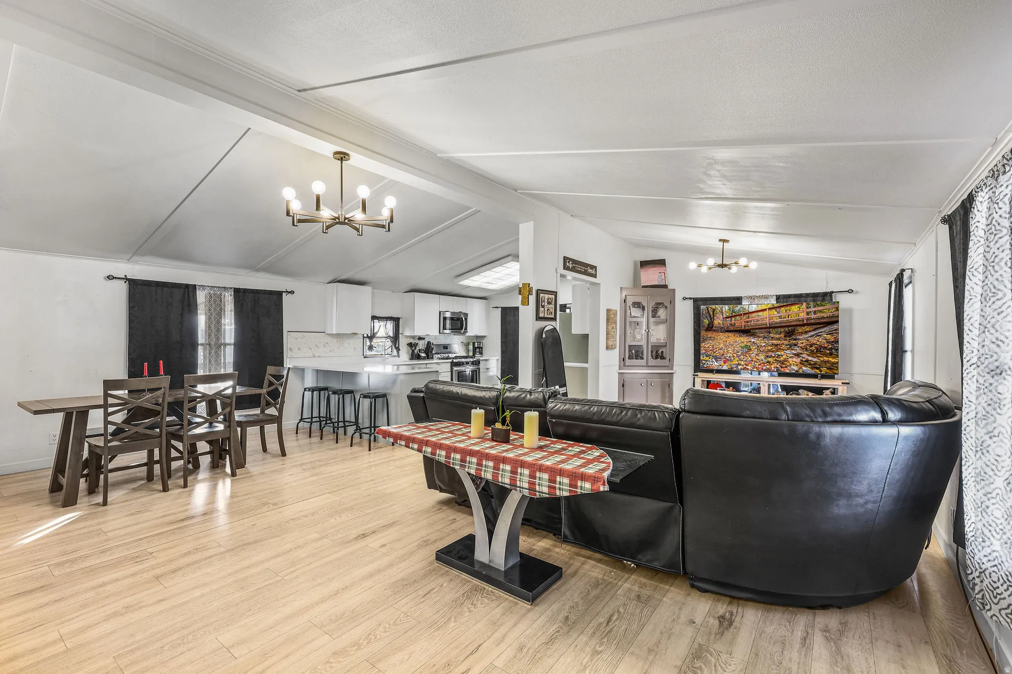 Living area featuring a chandelier and light wood-style floors