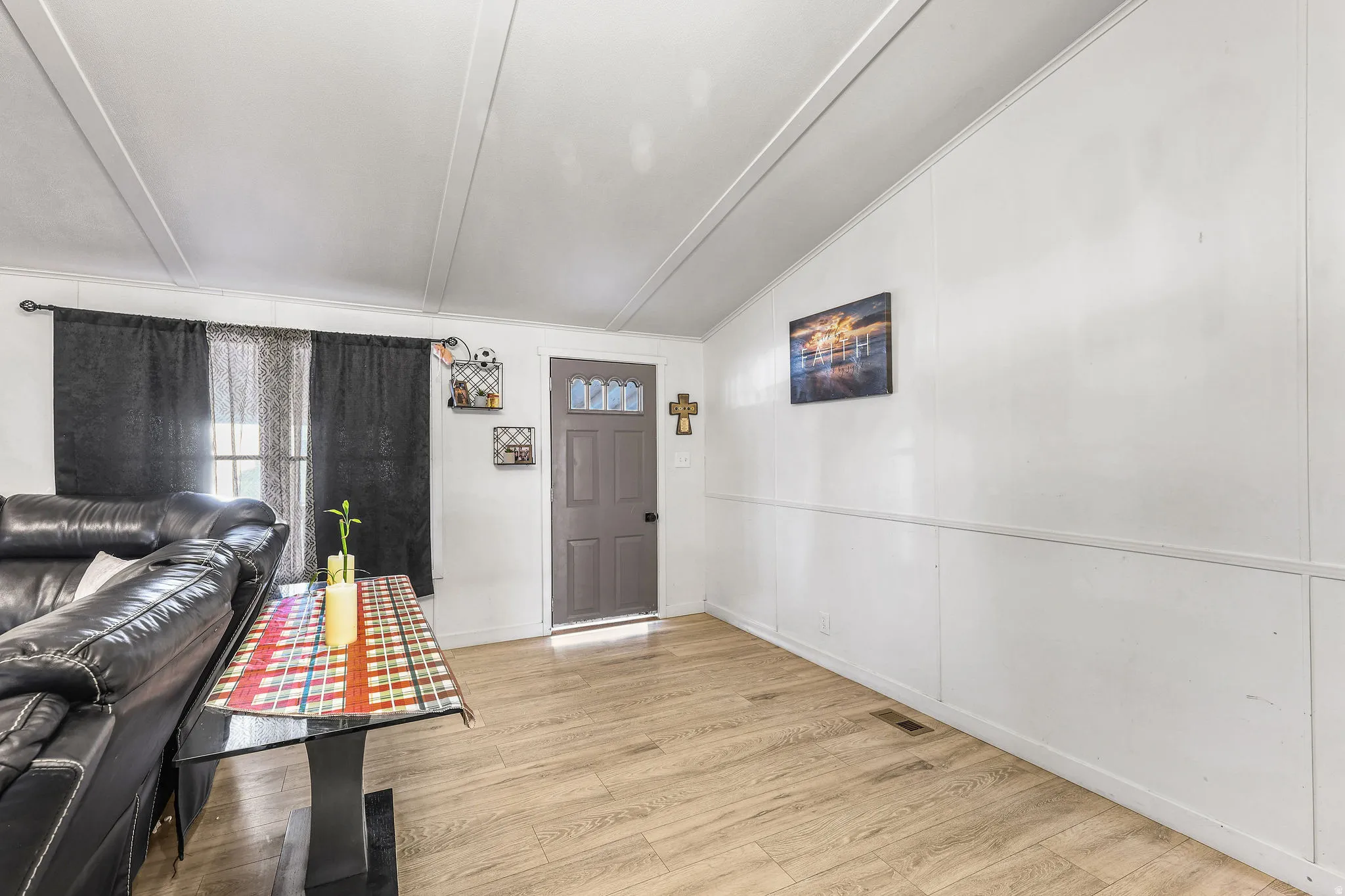Entryway with lofted ceiling and light wood-style floors