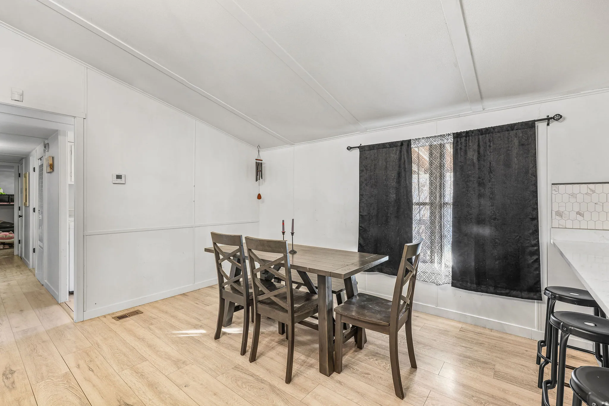 Dining space featuring vaulted ceiling and light wood-type flooring