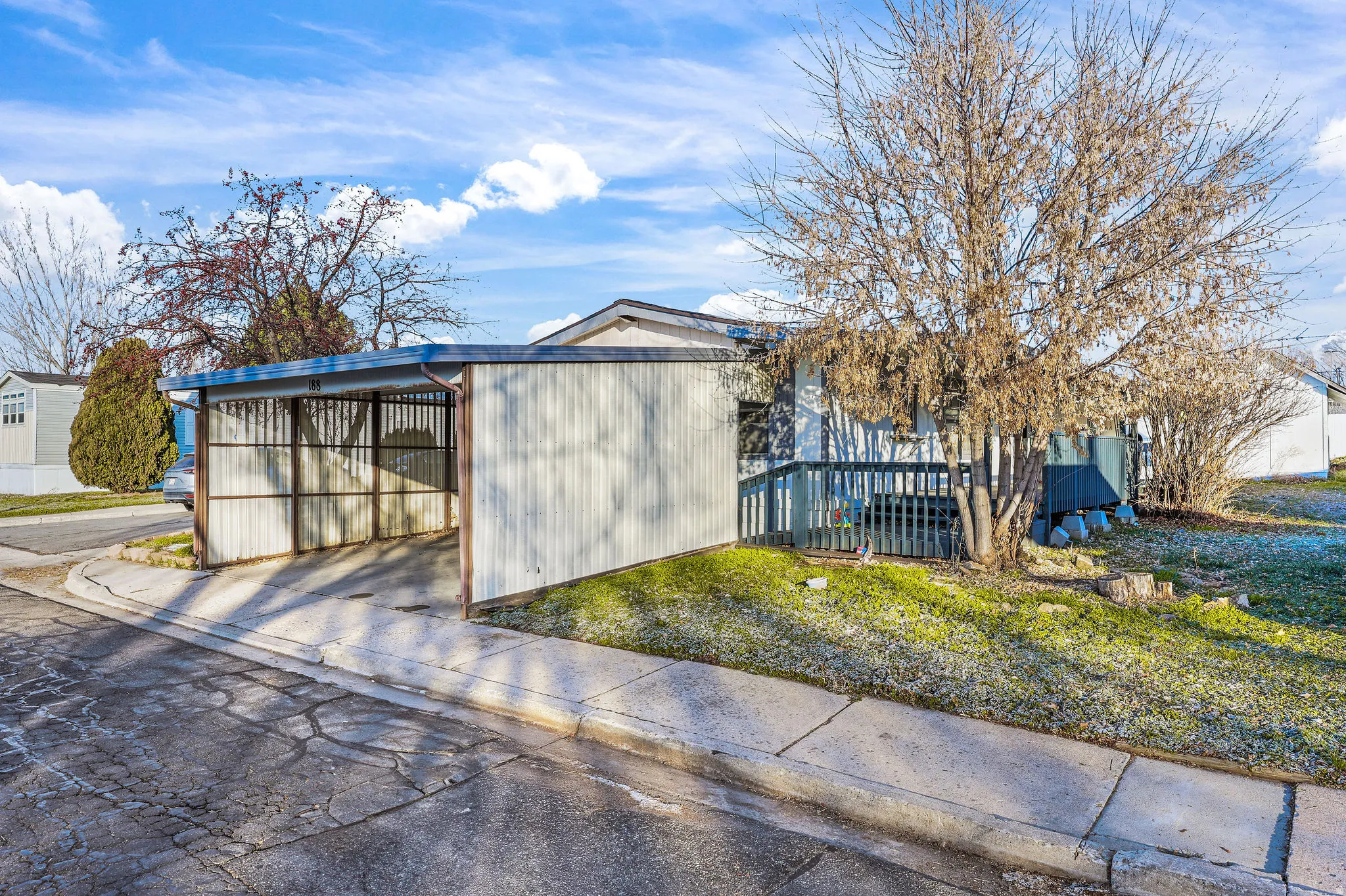 View of outbuilding featuring driveway and a carport