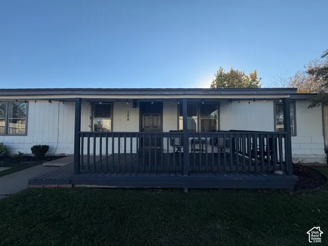 Front porch with dark wood-finish decking and railing