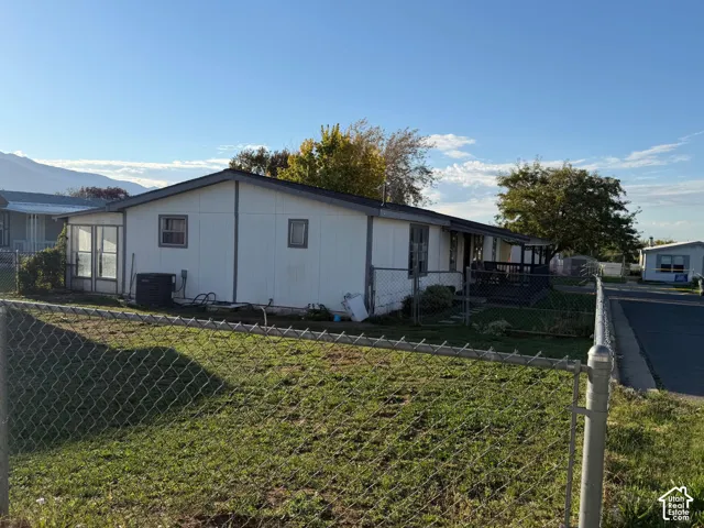White-sided exterior with a covered porch and fenced yard