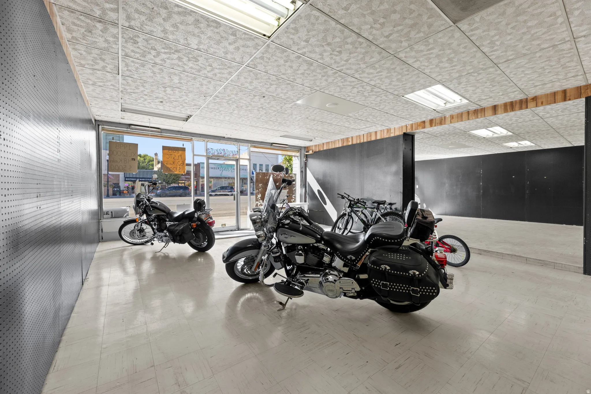 Exercise room with tile patterned floors and a drop ceiling