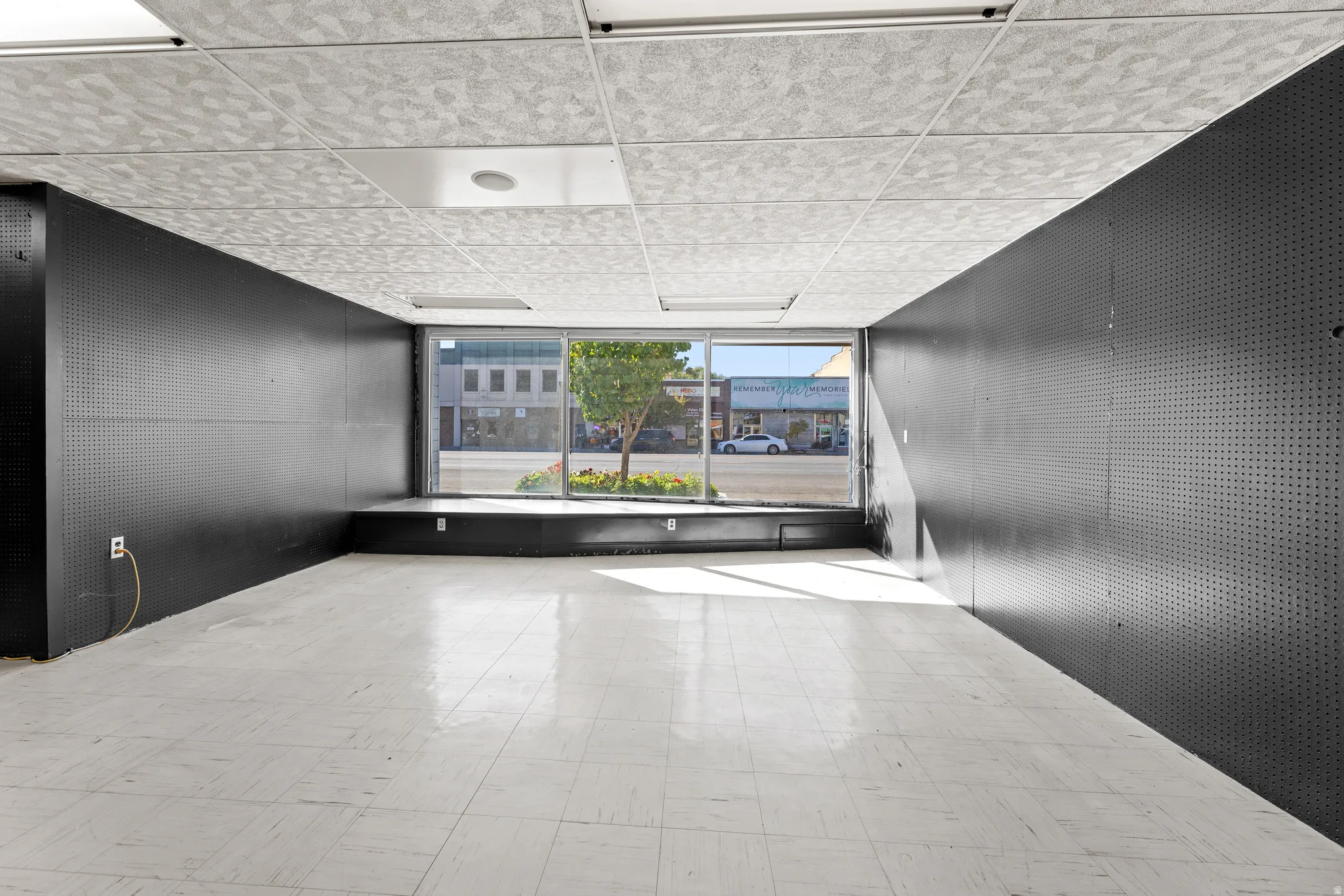 Unfurnished room with a paneled ceiling and tile patterned floors