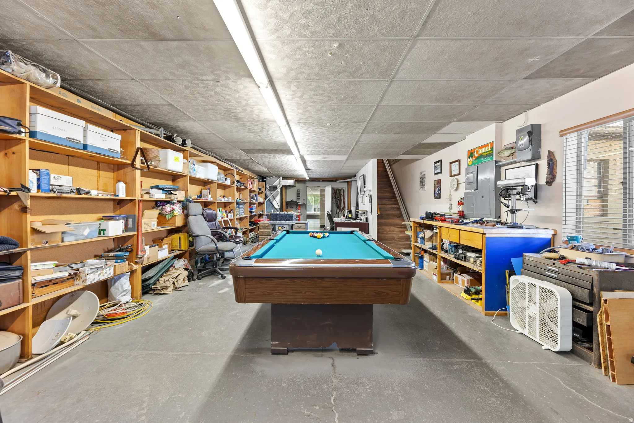 Recreation room featuring concrete floors, billiards, and electric panel