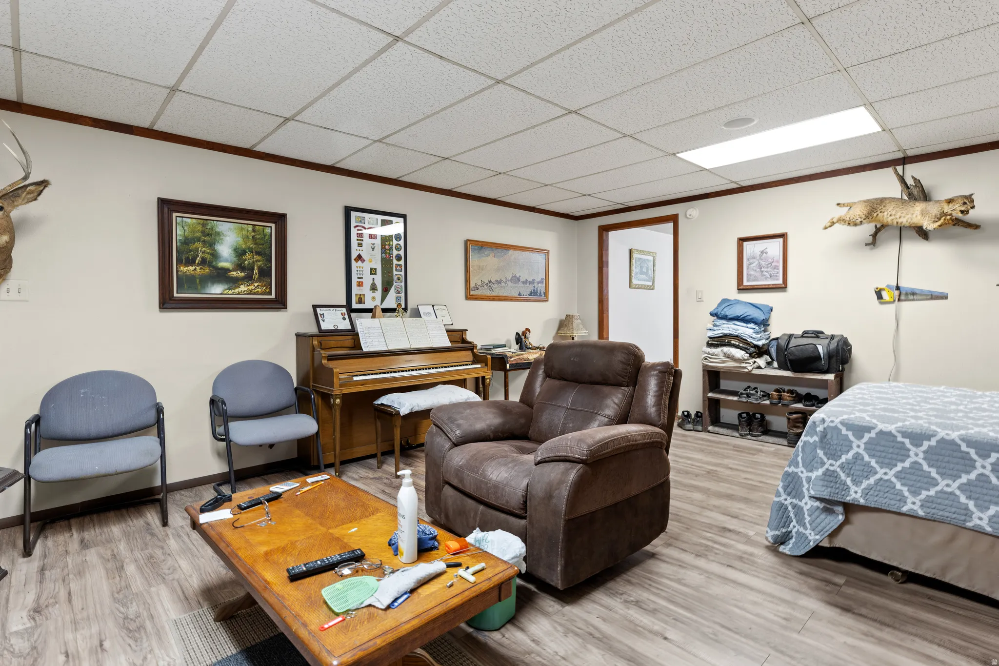 Bedroom featuring wood finished floors and a paneled ceiling