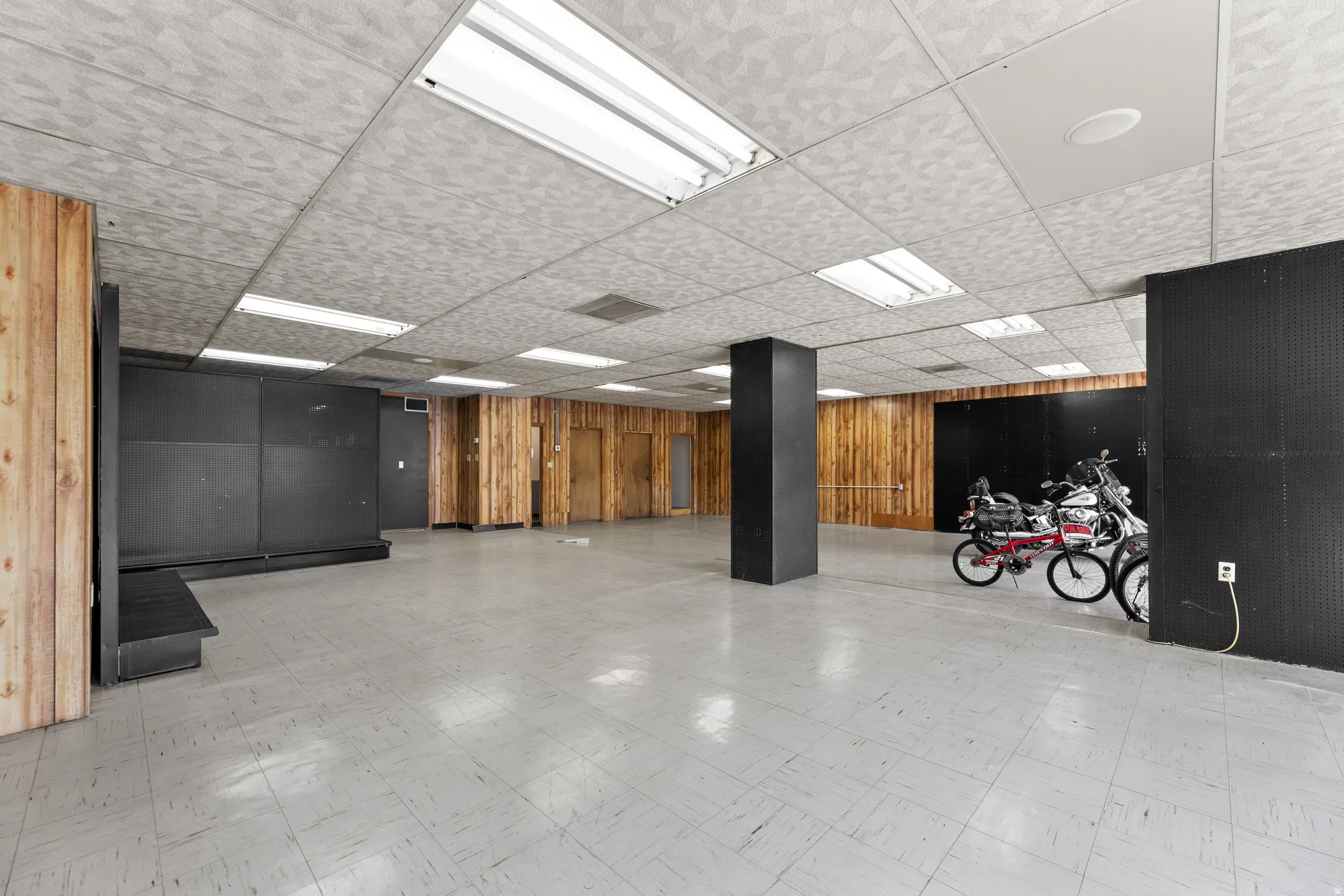 Misc room featuring wood walls and a drop ceiling