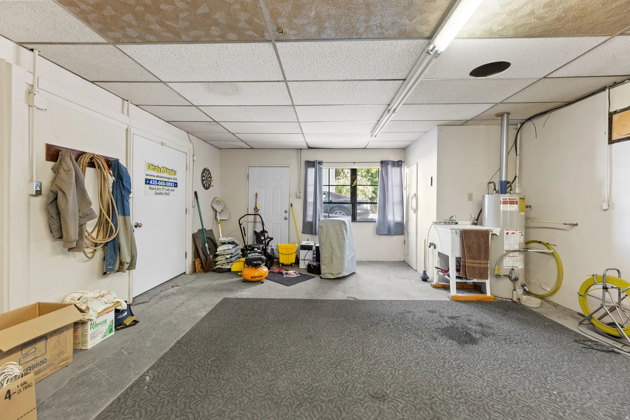 Miscellaneous room featuring a paneled ceiling and water heater