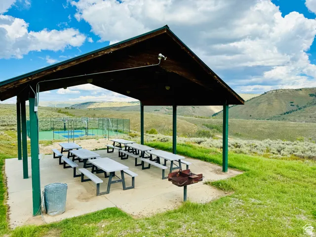 View of property's community featuring a mountain view, a patio area, and a view of rural / pastoral area