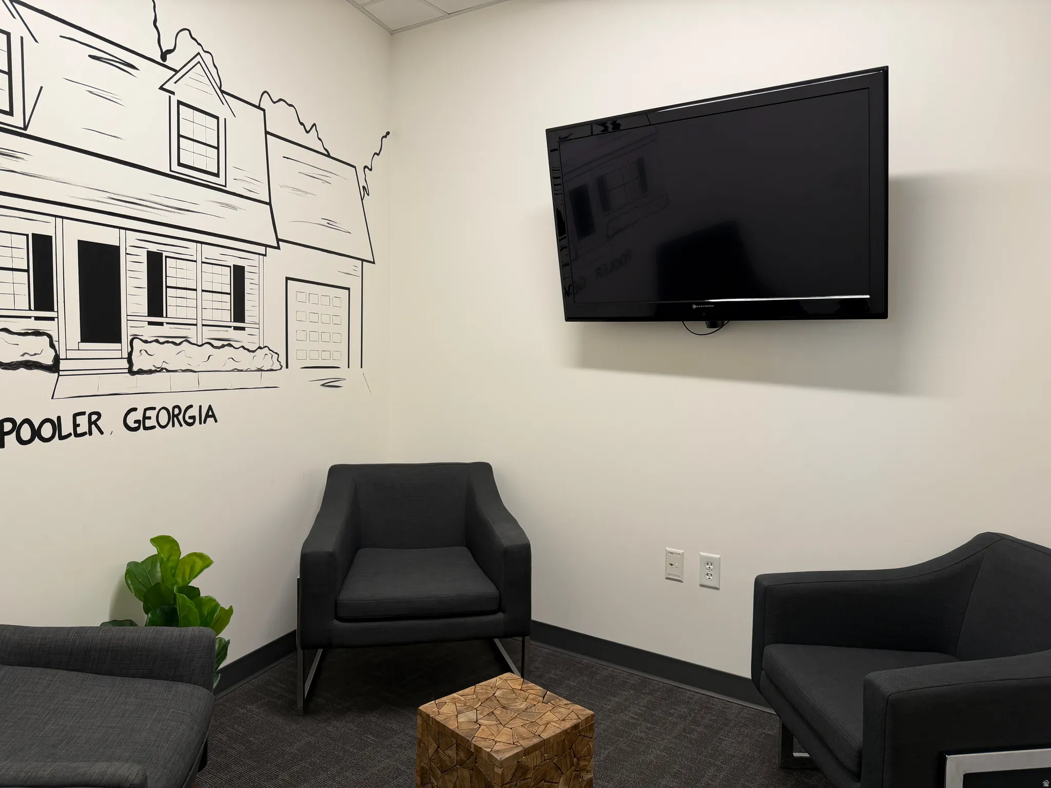 Living area with baseboards and carpet flooring