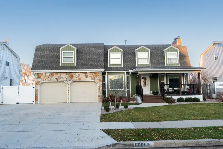 View of front of property featuring a gate, a porch, roof with shingles, driveway, and a chimney